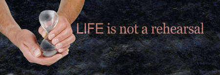 Life is not a rehearsal background banner - male hands holding an hour glass beside the phrase LIFE...