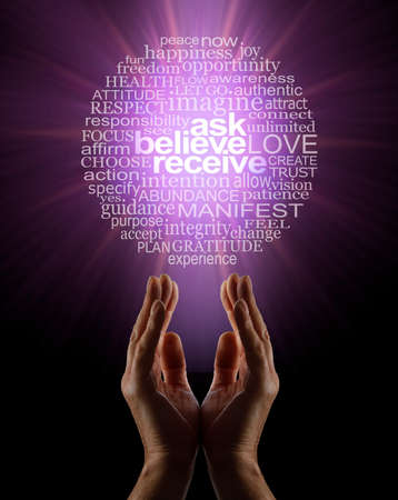 ASK BELIEVE RECEIVE in the power of manifesting abundance Word Circle - male parallel hands facing upwards towards magenta light containing word cloud against black backgroundの写真素材