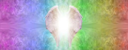 Chakra Rainbow Angel Therapy Message Banner - wide rainbow coloured graduated background with a pair of angel wings and white light placed centrally and copy space either sideの写真素材