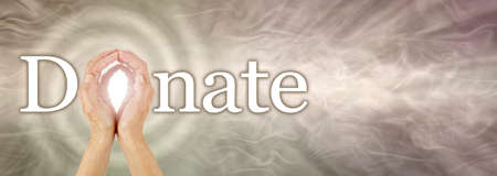 The effects of donating can spiral - female hands making the O in DONATE against a wide warm bronze...