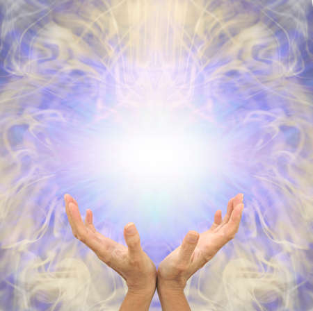 Sensing scalar healing energy message banner - female cupped hands reaching up to a white light energy orb against a lilac and gold symmetrical ethereal pattern backgroundの写真素材