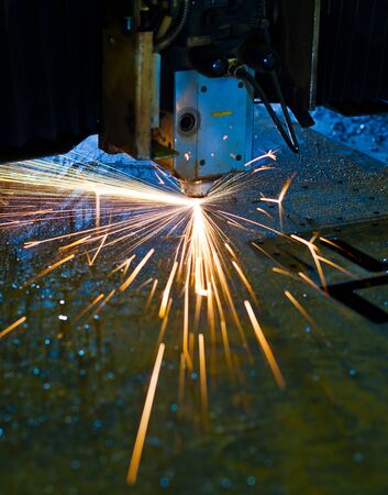 Laser cutting with sparks close upの写真素材