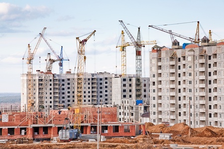 The construction of several large residential apartment buildings in the fieldの写真素材