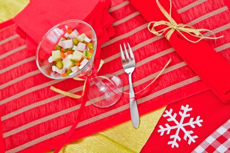 Beautifully decorated portion of Russian salad stands on the holiday tableの写真素材