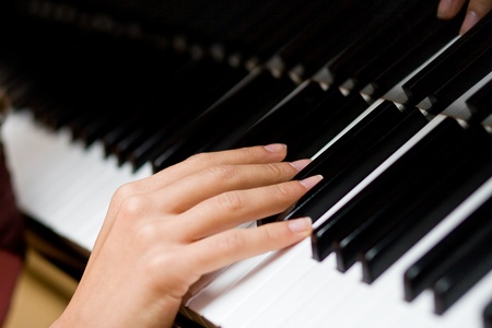 The gentle woman's hand on piano keysの写真素材