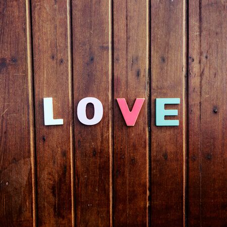 word love made up of colorful wooden letters on a wooden table. February 14, Valentineの写真素材