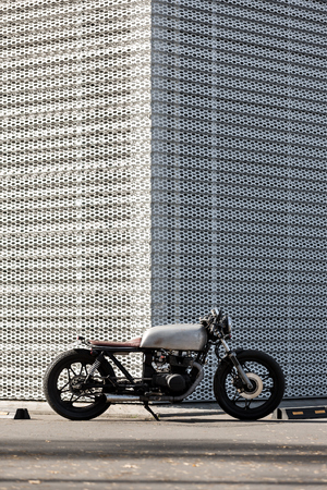 Custom motorbike parking near wall of finance building. Everything is ready for having fun driving...