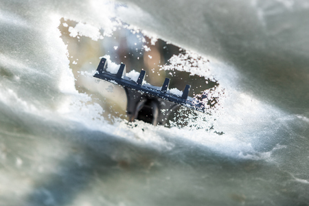 Closeup of woman cleaning car window from snow and ice. Scraping ice from a windshield has been taken from the inside of the car. Transportation winter driving weather people and vehicle conceptの写真素材