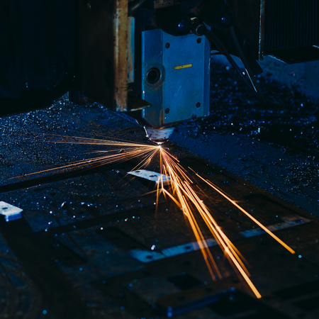 Laser cutting with sparks close upの写真素材