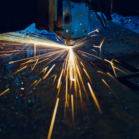 Laser cutting with sparks close upの写真素材