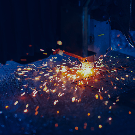 Laser cutting with sparks close upの写真素材
