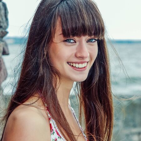 A beautiful girl with long hair coquettishly smilingの写真素材