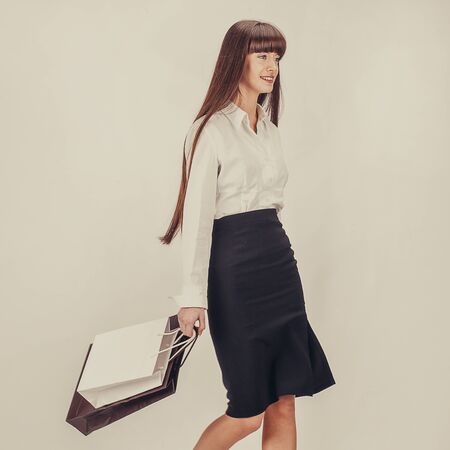 Young attractive girl enjoys a large number of purchases. Offline or online shopping concept. Modern woman enjoy her holidays. Money spending happy lady.の写真素材