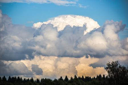 Storm clouds over the forest. Beautiful menacing sky over the field.の写真素材