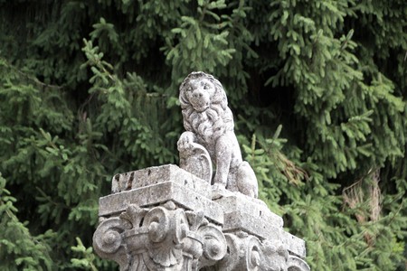 BRUNATE, ITALY - SEPTEMBER 4, 2017: stone lion statue in one of the villa of Brunate. Stone lion statue in front of the tree.のeditorial素材