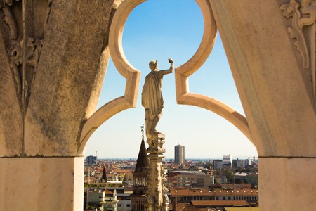 Milan, Italy - September 05, 2017: Milan Cathedral, Duomo di Milano â the gothic cathedral church of Milan. Architectural detail, marble statues on the roof Duomo. View on town Milan.のeditorial素材