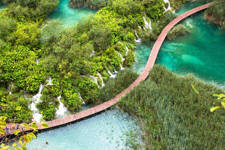 Plitvice lakes national Park, Croatia. Walkway bridge over the pond that passes by the amazing little waterfalls.の写真素材