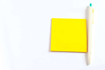 Colored notes papers on white background and penの写真素材