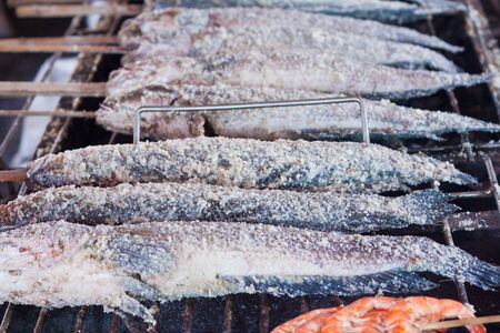 Grilled fish with salt on the stove  In the Thai market の写真素材