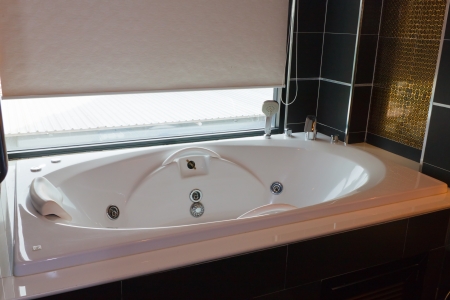 bathtub with swirling water  in bathroom の写真素材