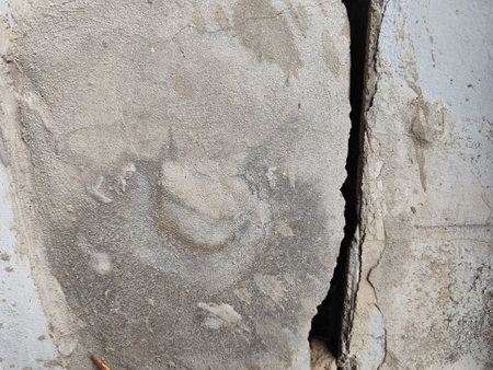 Broken concrete wall with hole in the floor. Abstract background.