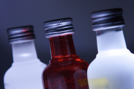 Three glass bottles with colored illuminationの写真素材