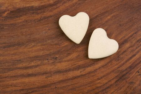pair of valentine hearts on wooden surfaceの写真素材