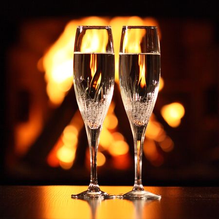 two glasses in front of fireplaceの写真素材