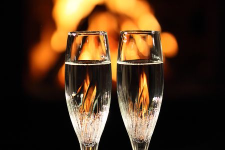 two glasses in front of fireplaceの写真素材