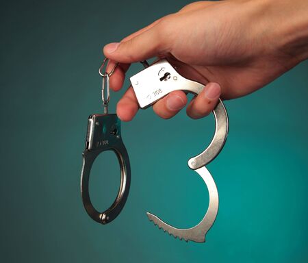 hand holding a handcuffsの写真素材