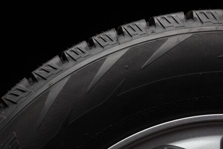 part of winter tyres isolated on black