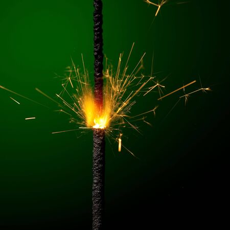 burning sparkler on green