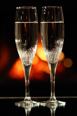 two glasses in front of fireplaceの写真素材