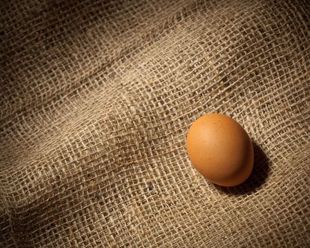 chicken egg on brown sackingの写真素材