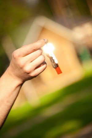 hand holding keys, house in the backgroundの写真素材