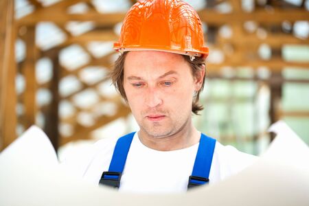 builder looking at the construction plan