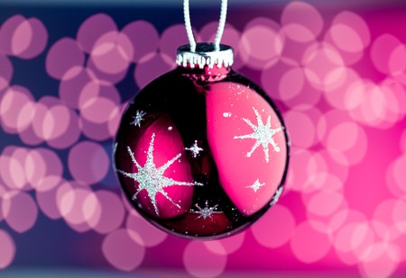 purple Christmas ball with defocused lightsの写真素材