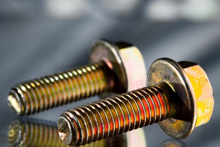 gold screw bolts with reflectionの写真素材