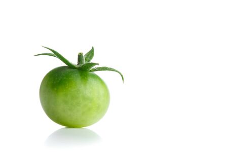 green unripe tomato isolated with copy-spaceの写真素材