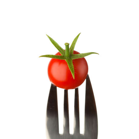 fork with cherry tomato isolated on whiteの写真素材