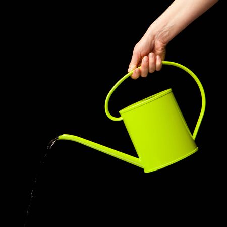 hand holding watering can isolatedの写真素材