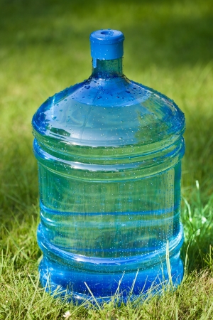 water big bottle on green grass backgroundの写真素材