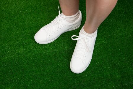 tennis sneakers on green