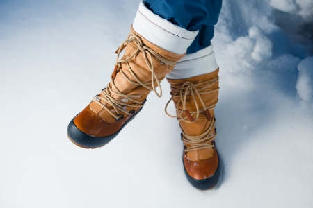 winter shoes in snow, close-upの写真素材