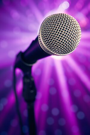 microphone against purple rays backgroundの写真素材