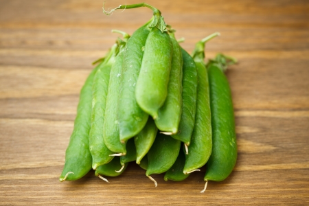 green peas pile on wooden plankの写真素材