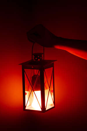 hand holding red lampの写真素材