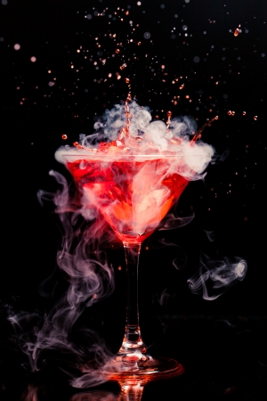 red cocktail with splash and ice vaporの写真素材