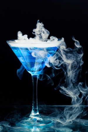 blue cocktail with splash and ice vaporの写真素材