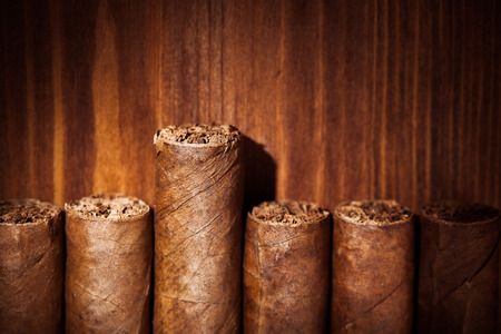 cigars on wooden background, closeup viewの写真素材